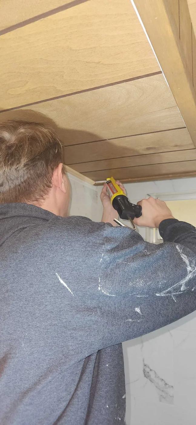 On the job, fitting a fixture overhead