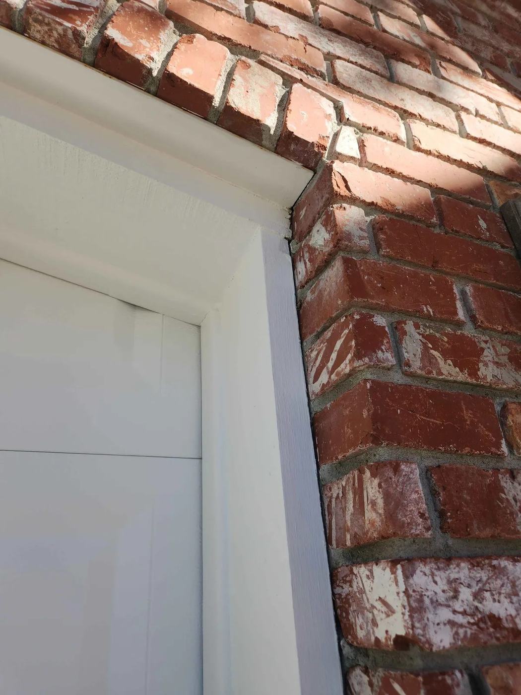 Crisp white trim cut in against a brick wall